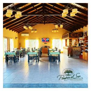 a dining room with tables and chairs in a restaurant at Pampas al Sur in Río Colorado
