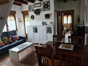 ein Wohnzimmer mit einem Tisch und einem blauen Sofa in der Unterkunft Dúplex Somo Beach in Somo