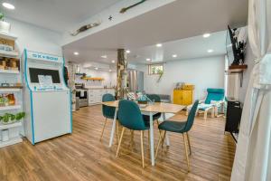 a kitchen and dining room with a table and chairs at The Ox + Bow in Portage La Prairie
