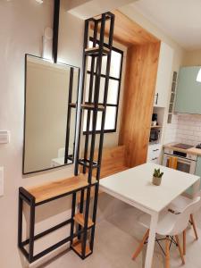 a mirror in a kitchen with a table and a ladder at Soul - the vibe of the city in Thessaloniki