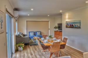 a dining room with a table and chairs at Seafoam, Cowes, New Home, Fast NBN WIFI in Cowes