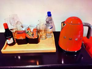 a cutting board with alcohol and glasses on a counter at Lipizzaner Lodge in Kyalami