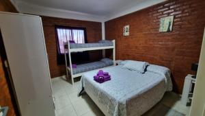 Un dormitorio con una cama con un juguete púrpura. en M&M Cipolletti en Cipolletti