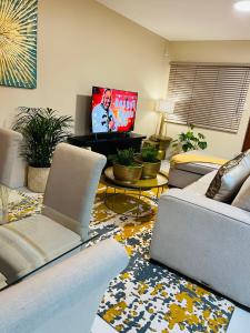 a living room with a couch and a tv at Isibani luxury apartment in Richards Bay