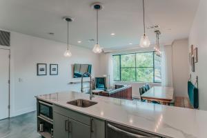 a kitchen with a sink and a counter top at Colton House Hotel in Austin