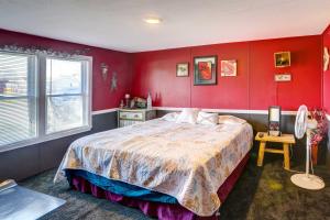 a bedroom with red walls and a large bed at Port Clinton House with Boat Dock on Portage River! in Port Clinton