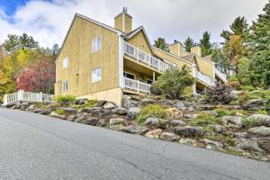 a large house on a hill with rocks at Stowe Condo with Deck and Mountain Views! in Stowe
