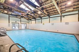 a swimming pool with blue water in a gym at Stowe Condo with Deck and Mountain Views! in Stowe