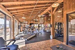 a gym with treadmills and elliptical machines at Stowe Condo with Deck and Mountain Views! in Stowe