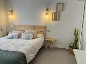 a bedroom with a bed with two pillows and a plant at Apartamento Veradulce, Vera Playa in Vera +26 photos