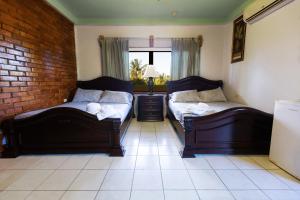 Ένα ή περισσότερα κρεβάτια σε δωμάτιο στο Sea Eye Hotel - Tropical Building