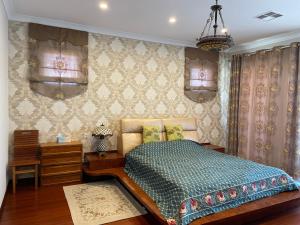 a bedroom with a bed and a dresser and curtains at Comfortable Luxury Home in Perth