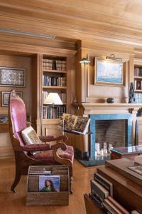 a living room with a fireplace and a chair at As Janelas Verdes Inn - Lisbon Heritage Collection - Riverside in Lisbon