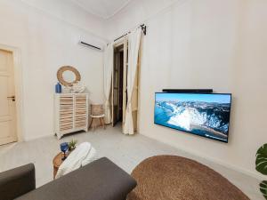 a living room with a flat screen tv on a wall at Magellano Suite. Fronte Mare + Free Park + Wi-Fi in Porto Empedocle
