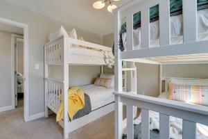 a room with two bunk beds and a hallway at Lakefront Home Rental with Hot Tub in White Lake! in Oxbow