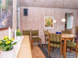 a dining room with a table and chairs at 9 person holiday home in Grenaa in Grenå