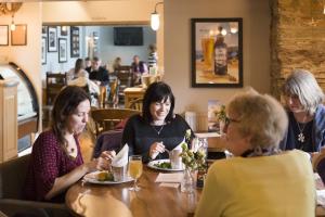 a group of women sitting at a table in a restaurant at Hope & Anchor in Hope Cove
