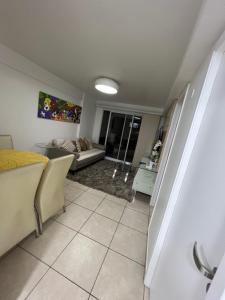 a living room with a couch and a table at Apartamento Praia do futuro Bech Village in Fortaleza