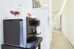 a microwave oven sitting on top of a tv at Firmafede Guest House in Sarzana