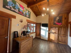 a room with wooden ceilings and a room with a table at cabañas Mazzatl jacuzzy in Mazamitla