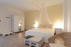 a bedroom with a white bed with a canopy at Casetta Don Carlino in Campomarino