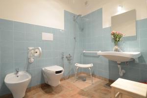 a bathroom with a sink and a toilet and a bidet at Casetta Don Carlino in Campomarino +59 photos