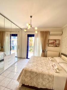 a bedroom with a large bed and a mirror at Fourka House in Kassandra