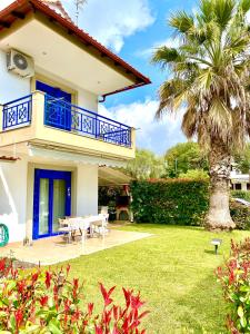a house with a patio and a palm tree at Fourka House in Kassandra