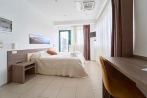 a bedroom with a bed and a large window at Firmafede Guest House in Sarzana