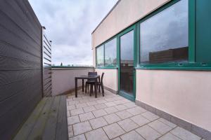 a patio with a table and chairs on a building at Firmafede Guest House in Sarzana