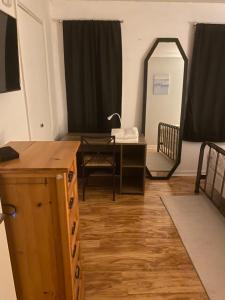 a room with a table and a mirror and a desk at monthly only shared apt in Newport