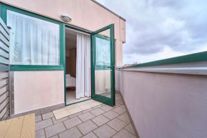 a balcony with sliding glass doors on a building at Firmafede Guest House in Sarzana +40 photos