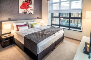 Postel nebo postele na pokoji v ubytování Fabryka Wełny Hotel & Spa