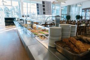 a buffet line with plates and pastries in a restaurant at Etelä-Pohjanmaan Opisto in Ilmajoki