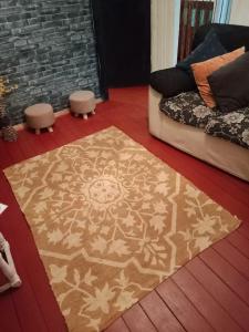 a bedroom with a rug on the floor with a bed at Cabañas Josabi in Concepción