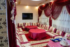 a living room with a couch and a table at Riad dar asalam in Agadir