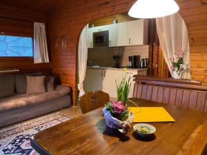 a living room with a table and a couch at Cozy holiday home on a horse farm in the Lüneburg Heath in Eschede