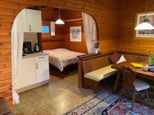 a bedroom with a bed and a desk in a room at Cozy holiday home on a horse farm in the Lüneburg Heath in Eschede