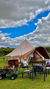 a tent and two chairs and a table and a tent at Coonawarra Bush Holiday Park in Coonawarra