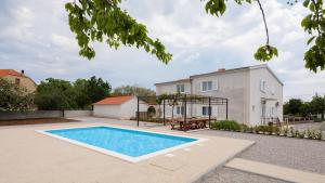 a swimming pool in the backyard of a house at Family friendly house with a swimming pool Katuni, Zagora - 20651 in Šestanovac