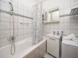 a white bathroom with a tub and a sink at Family friendly house with a swimming pool Katuni, Zagora - 20651 in Šestanovac +18 photos