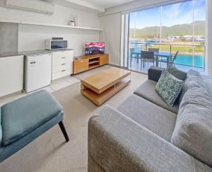 a living room with a couch and a table at Blue on Blue Superior Studio Room 1351 in Nelly Bay