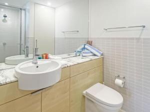 a bathroom with a sink and a toilet and a mirror at Blue on Blue Superior Studio Room 1351 in Nelly Bay +4 photos