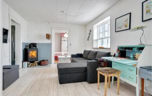 a living room with a couch and a table at Cozy Home In Vestervig With Kitchen in Vestervig