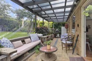 a patio with a couch and a table at Blackheath Suite (2 b/rooms) Family/Pet Friendly in Blackheath