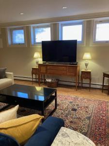 a living room with a flat screen tv at Pineapple House, Spacious 1st Floor Apartment! City Center! 96 Walk Score! FREE parking! in Denver