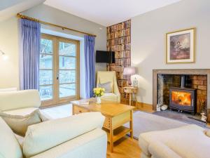 a living room with a couch and a fireplace at East Lodge in Falkland