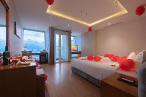 a hotel room with two beds with red balloons on them at Le's Cham Hotel in Nha Trang