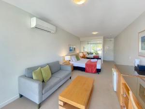 a living room with a couch and a bed at Blue on Blue Studio Room 1352 in Nelly Bay