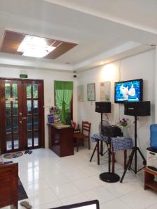 a living room with a flat screen tv on the wall at Raje Residence in El Nido
